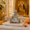 Guru Nanak Dev Ji Idol in Silver Finish displayed on home mandir with brass diyas, marigold flowers and incense sticks for Gurpurab puja