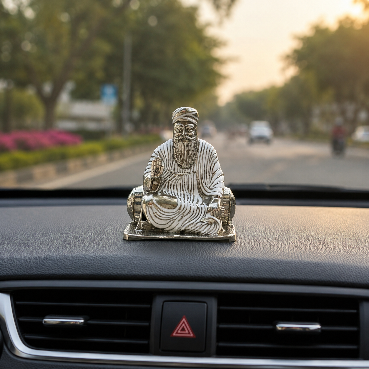 Guru Nanak Dev Ji Silver Finish Brass Idol placed on car dashboard, compact devotional murti for travel blessings and protection