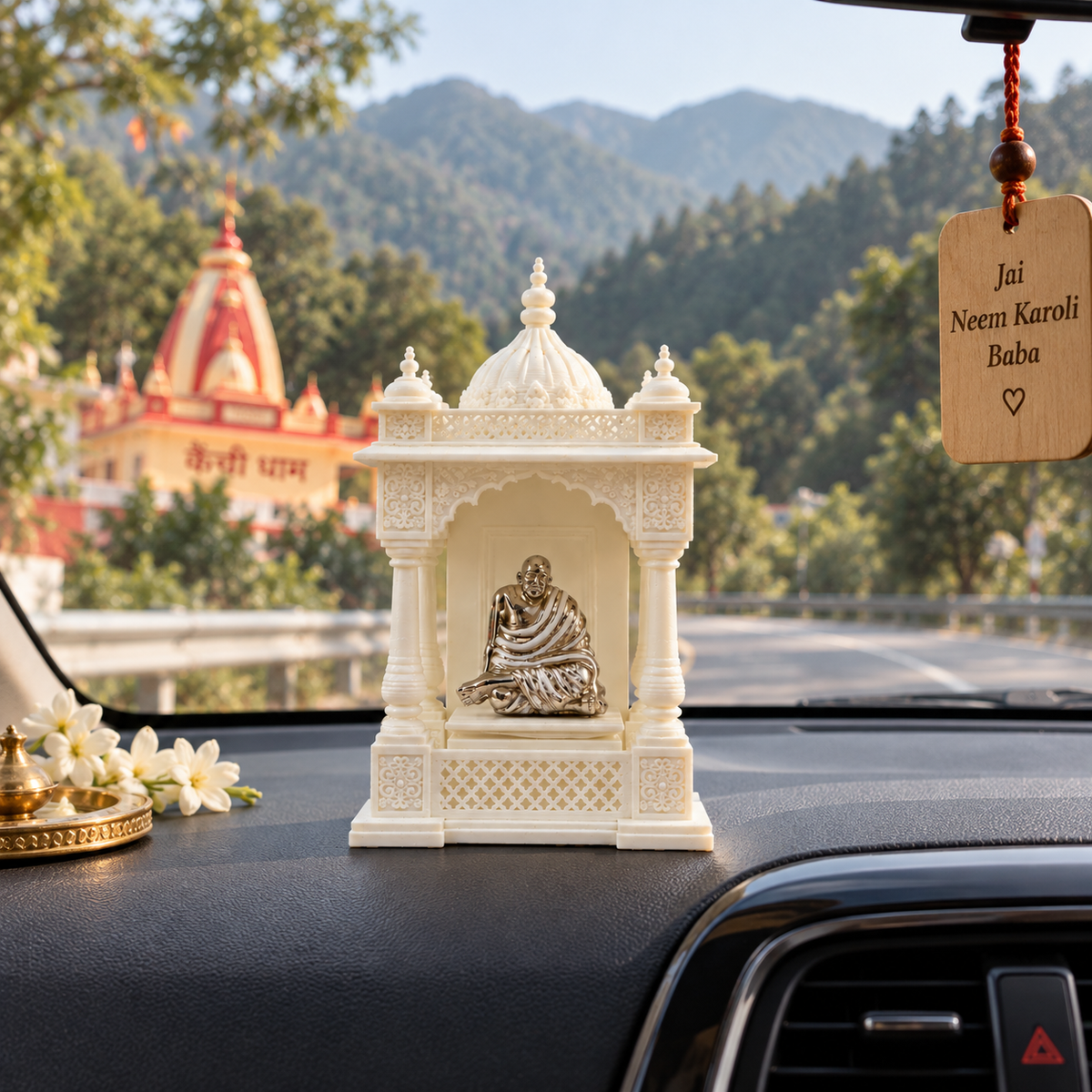 Compact Neem Karoli Baba idol with white resin mandir displayed on a car dashboard