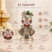 Jagannath Ji brass murti with silver finish displayed in a home temple with flowers and diya