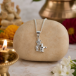 Man wearing Ganesh Ji with Shivling pendant in brass silver finish while praying