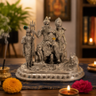 Shiv Parivar Silver Finish Brass Idol — Shiva Parvati Ganesh Kartikeya Nandi on ornate platform with diyas