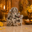 Bagla Mukhi Maa Silver Finish Idol on wooden table with diya, flowers and incense — home decor setting