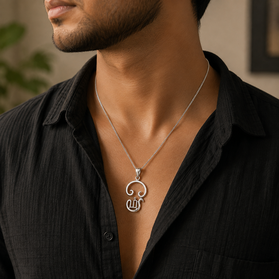 Tamil Om pendant in brass silver finish worn by woman in white embroidered kurta showing pendant close to chest