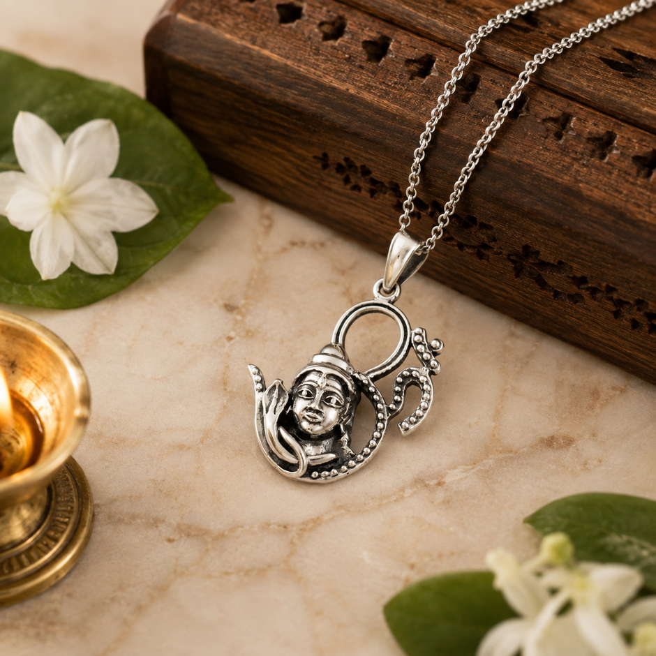 Mahadev OM Pendant on marble surface with diya, incense box and white flowers — elegant premium styling
