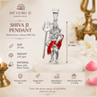 Man in black kurta with sacred white tilak and red bindi on forehead devotionally holding Mahadev Ji standing Shiva brass silver red enamel pendant on silver chain with Shiva idol, lit brass diyas and marigold flowers in home temple background