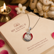 Ganesh Ji brass silver finish pendant with red enamel ring CZ crown and black sunburst rays on silver chain on My Guru Ji branded cream card reading may Lord Ganesha remove all obstacles and bless you always, with white Ganesha idol, lit diya, white jasmine flower and rose petals