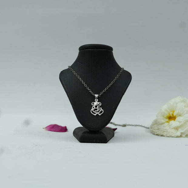 My Guru Ji silver finish brass pendant featuring Lord Ganesh and a Swastik symbol on a black display stand
