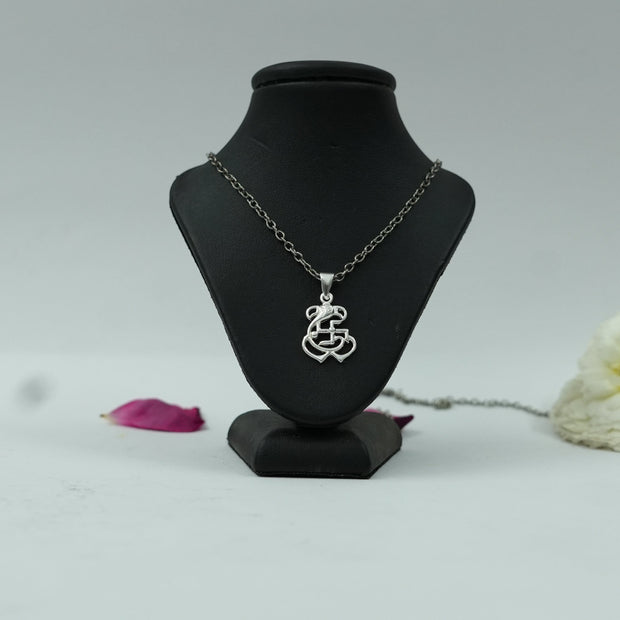 My Guru Ji silver finish brass pendant featuring Lord Ganesh and a Swastik symbol on a black display stand