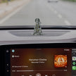 My Guru Ji silver finish brass Hanuman idol in sitting blessing posture displayed on a car dashboard
