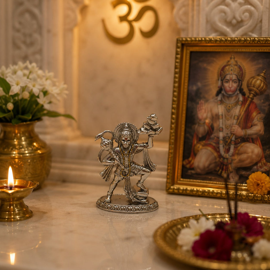My Guru Ji silver finish brass Veer Hanuman Ji idol carrying Sanjeevani mountain on a home temple altar.