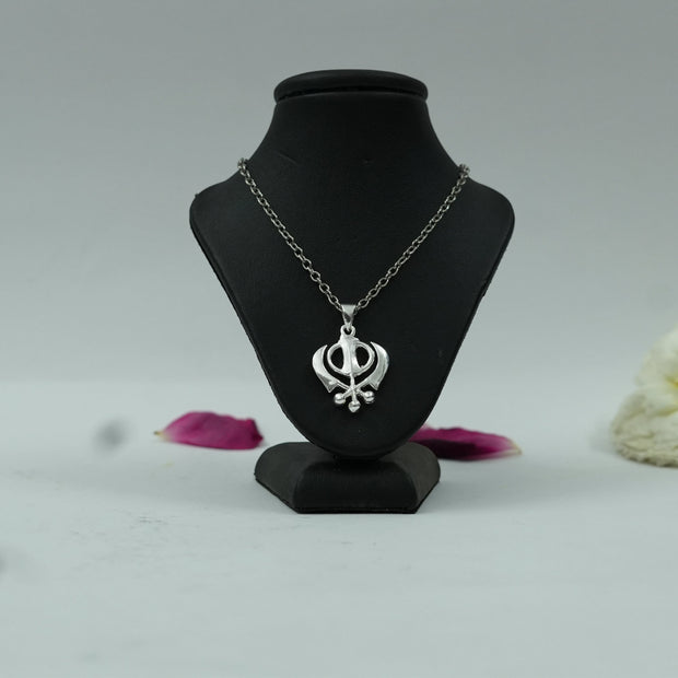 My Guru Ji Khanda Sahib pendant in silver-finished brass displayed on a black mannequin stand.