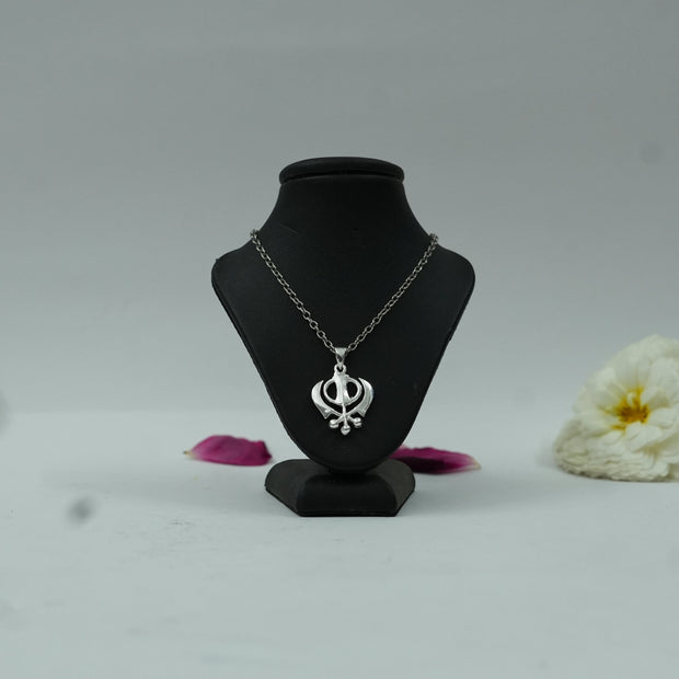 My Guru Ji silver-finish brass Khanda Sahib pendant on a black display stand with a delicate chain