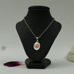 My Guru Ji silver finish brass pendant featuring a red enamel Khanda symbol displayed on a black mannequin bust