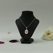 My Guru Ji silver finish brass pendant featuring a red Khanda symbol on an oval base displayed on a black bust