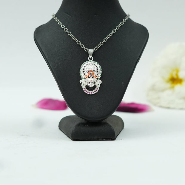 My Guru Ji Khatu Shyam Baba pendant in brass with a silver finish and colorful accents on a black display stand