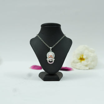 My Guru Ji Khatu Shyam Baba pendant in brass with a silver finish and colorful accents on a black display stand.