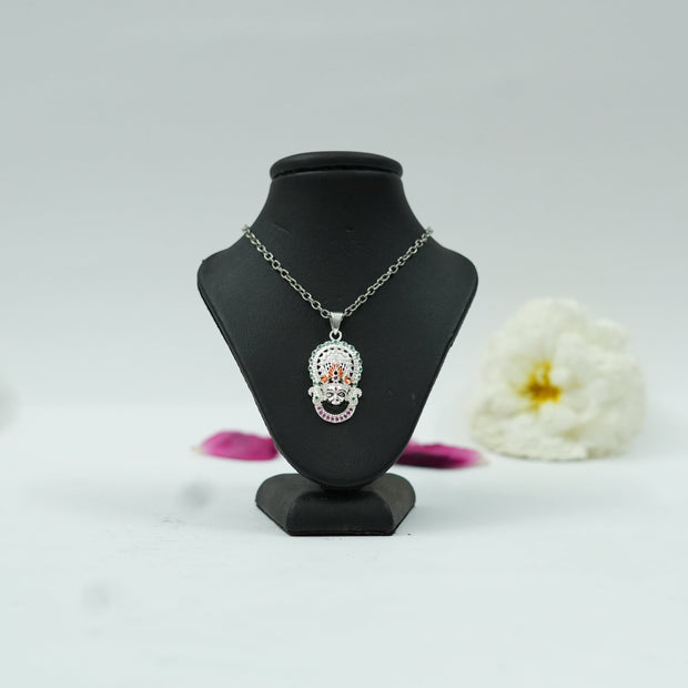 My Guru Ji Khatu Shyam Baba pendant in brass with a silver finish and colorful accents on a black display stand.