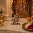 My Guru Ji handcrafted brass Maa Durga idol with silver finish, seated on a lion, displayed on a home temple altar.
