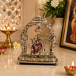 My Guru Ji Maa Durga idol in silver finish brass, seated on a lion under an ornate temple arch with a hanging bell.