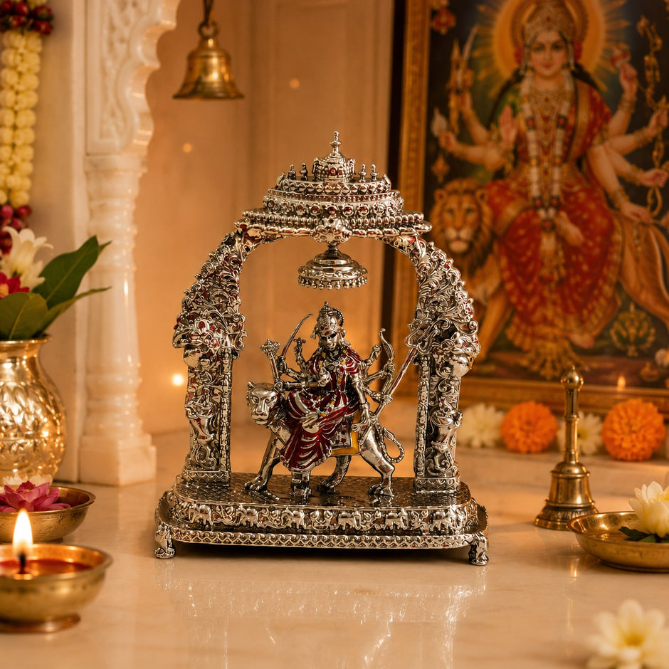 My Guru Ji Maa Durga idol in silver finish brass, seated on a lion under an ornate temple arch with a hanging bell.