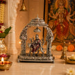 My Guru Ji Maa Durga idol in silver finish brass, seated on a lion under an ornate temple arch with a hanging bell.