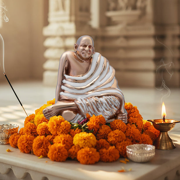 My Guru Ji Neem Karoli Baba brass idol sitting on marigold flowers with incense and a lit diya for meditation