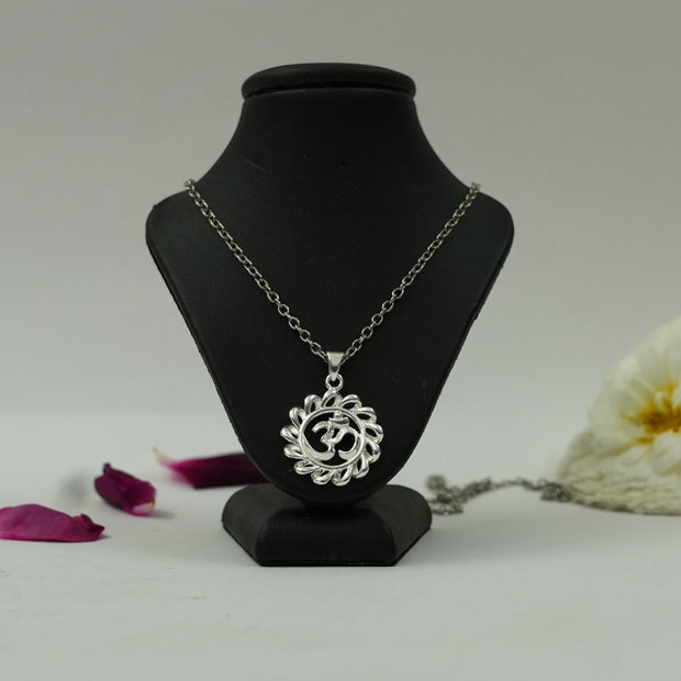 My Guru Ji silver-finish Om circle pendant on a black display stand with decorative flower petals