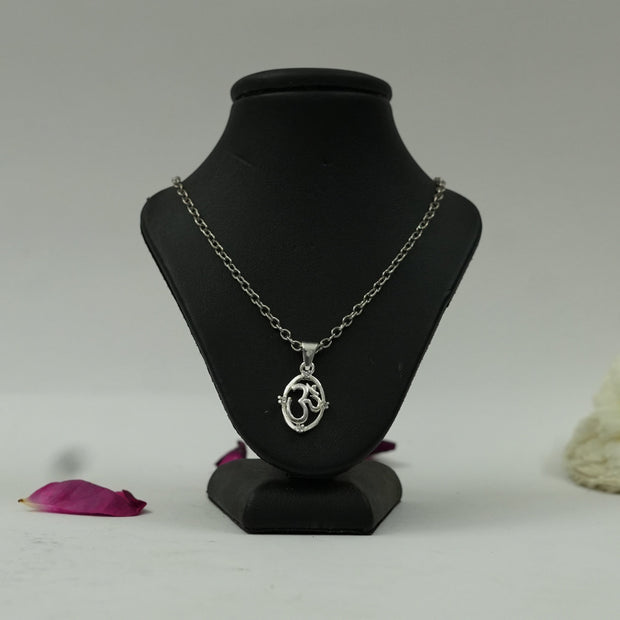 My Guru Ji silver finish OM symbol pendant on a black display stand with a delicate chain