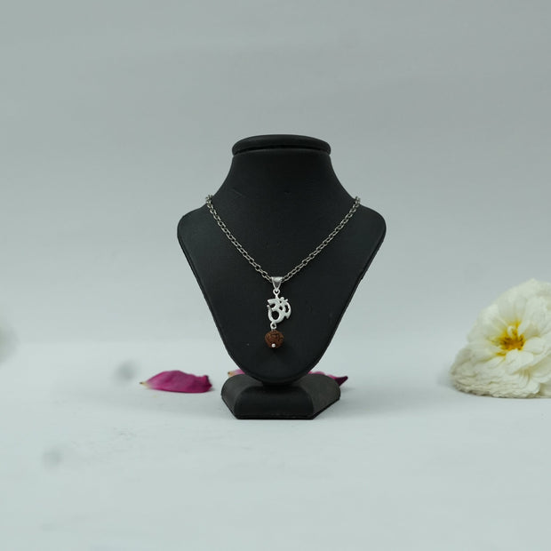 My Guru Ji Om symbol pendant with a Rudraksh bead, featuring an antique silver finish on a display bust.