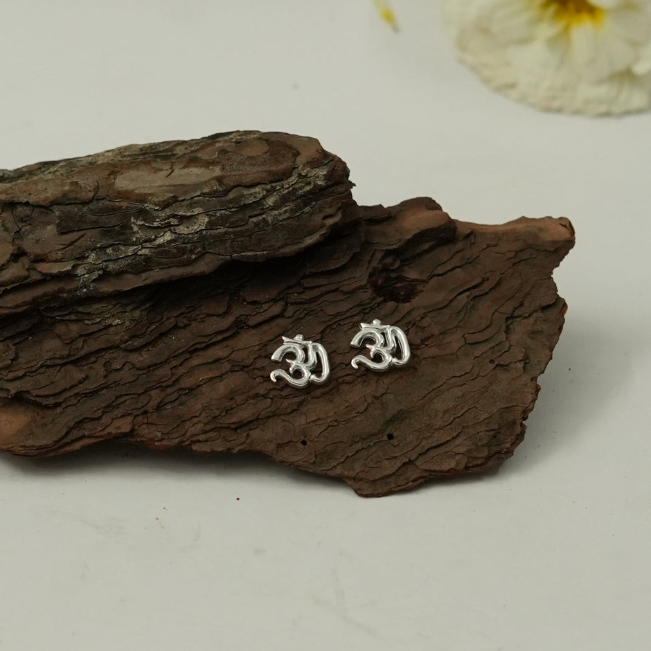 My Guru Ji Om symbol stud earrings in silver finish, crafted from brass for a minimal spiritual jewelry look.