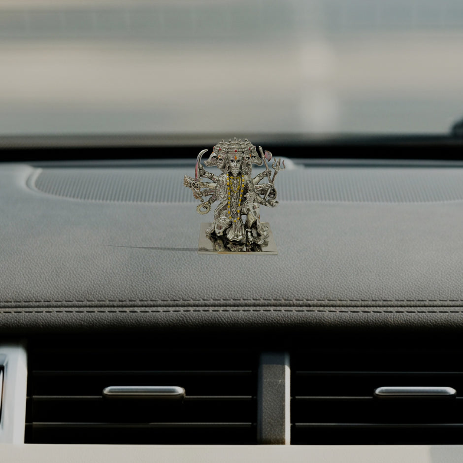 My Guru Ji Panchmukhi Hanuman idol in silver-finished brass, displayed on a car dashboard for spiritual protection.