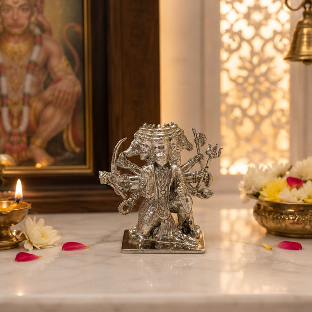My Guru Ji Panchmukhi Hanuman idol in silver-finished brass, featuring five faces and intricate detailing on a table.