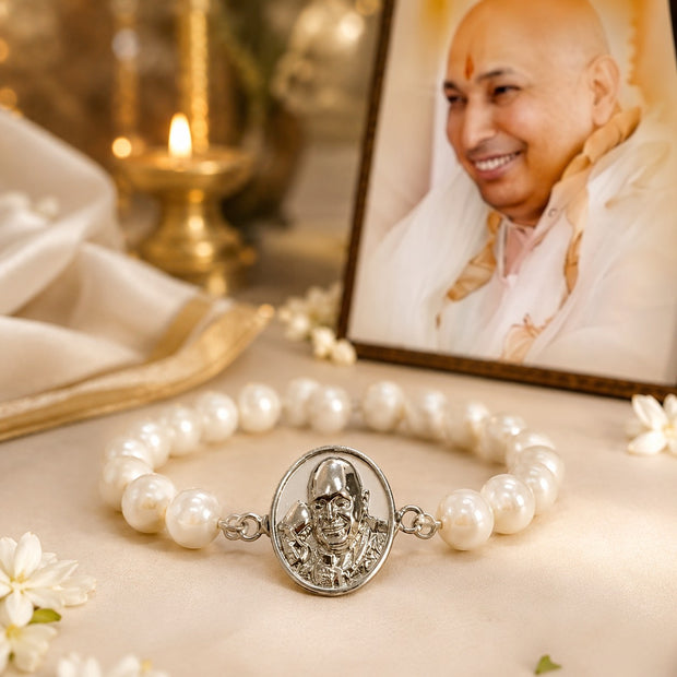 My Guru Ji pearl bracelet with a silver-finish brass charm featuring a portrait, displayed near a framed photo of Guru Ji.