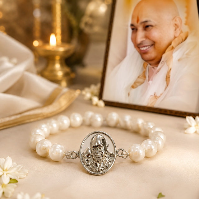 My Guru Ji pearl bracelet with a silver-finish brass charm featuring a portrait, displayed near a framed photo of Guru Ji.