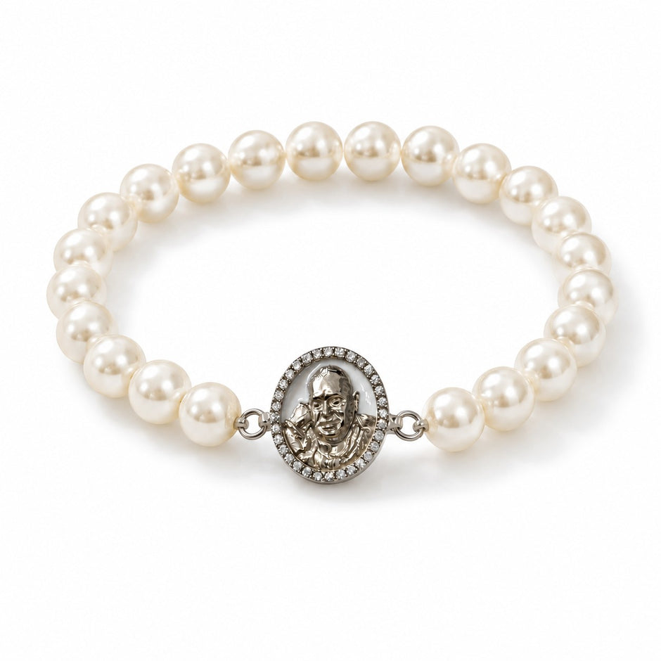 My Guru Ji pearl bracelet featuring a silver-finish brass charm with a detailed portrait, set on white pearl beads.