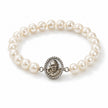 My Guru Ji pearl bracelet featuring a silver-finish brass charm with a detailed portrait, set on white pearl beads.