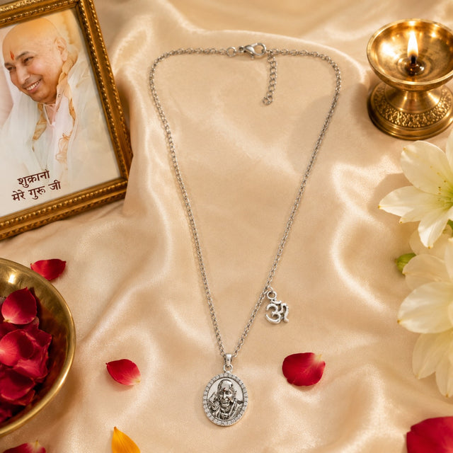 My Guru Ji silver-finish brass pendant featuring Guru Ji Bade Mandir portrait, CZ stone border, and OM charm on chain.