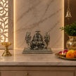 My Guru Ji handcrafted brass Ram Darbar idol with a silver finish, displayed on a marble altar with a lit diya.