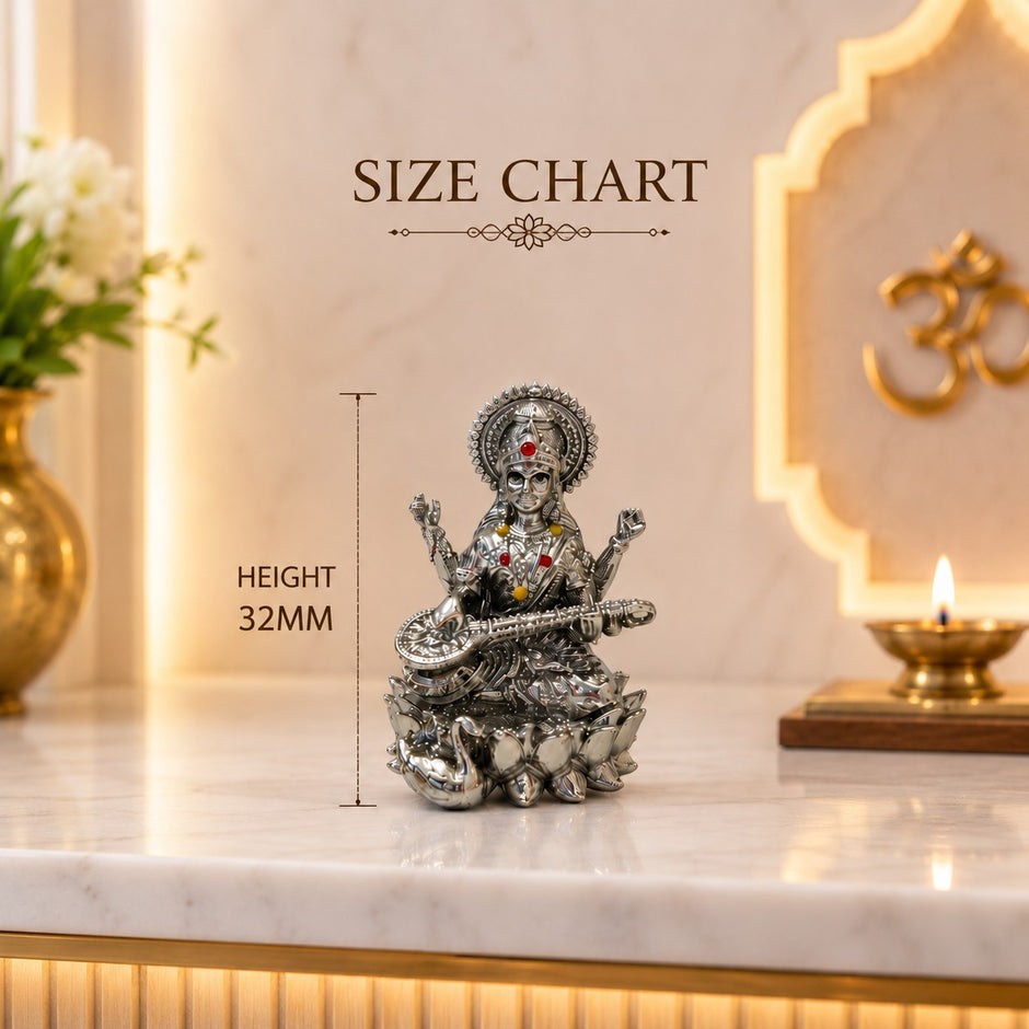 My Guru Ji silver finish brass Maa Saraswati idol seated on a lotus with a veena, featuring decorative stone accents.