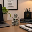 My Guru Ji silver finish brass Maa Saraswati idol with Veena on a lotus, displayed on a desk with office stationery.