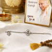 My Guru Ji silver-plated brass bracelet featuring a sacred Guru Ji charm and adjustable chain on a white cloth.
