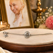 My Guru Ji silver-plated brass bracelet featuring a Guru Ji portrait charm and adjustable chain on a display stand.