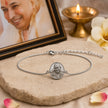 My Guru Ji silver finish brass bracelet featuring a sacred Guru Ji portrait charm and adjustable chain on stone