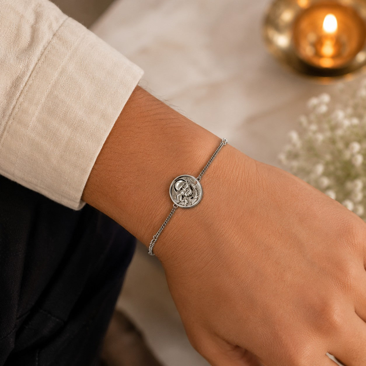 My Guru Ji silver finish brass bracelet featuring a sacred Guru Ji charm on a delicate adjustable chain on a wrist.
