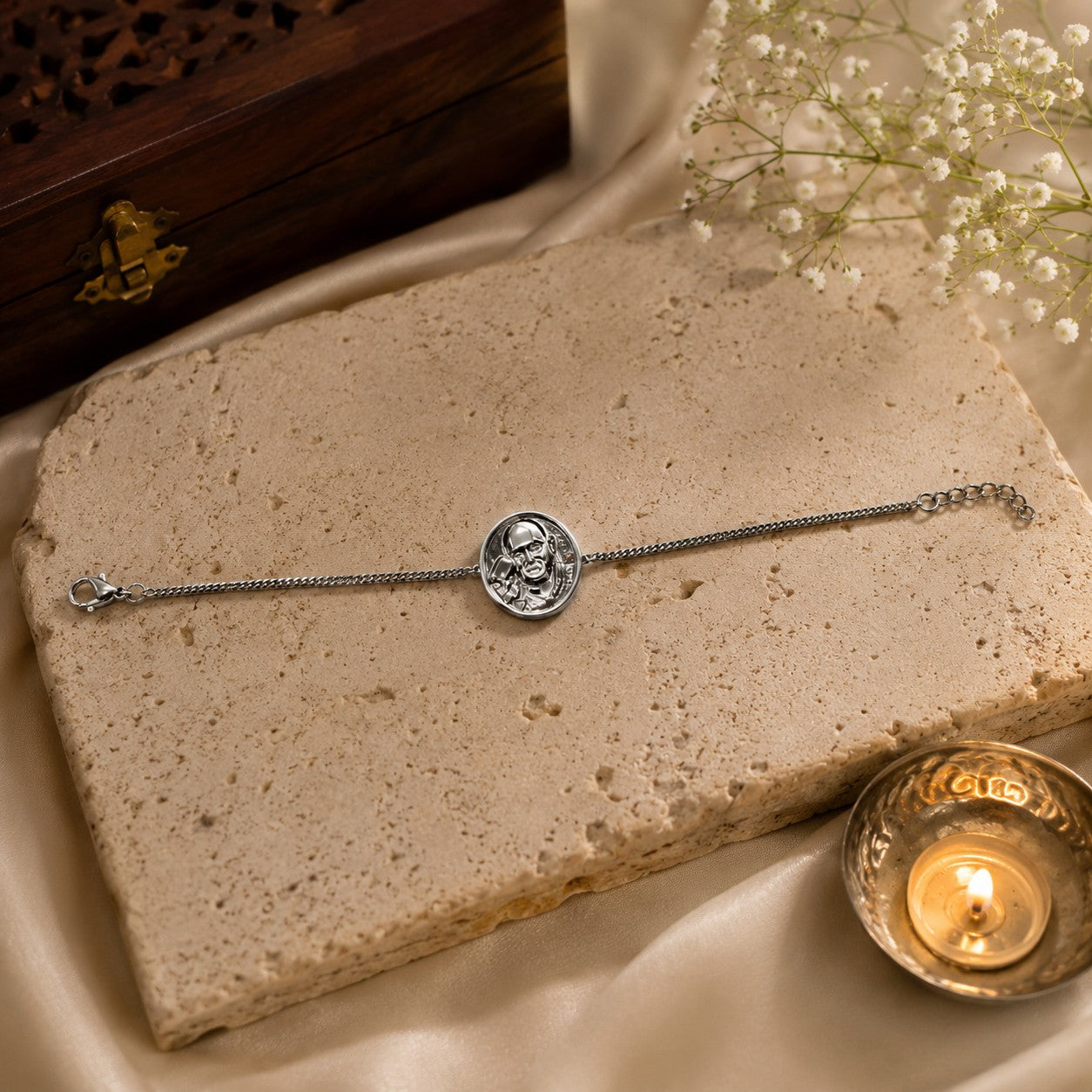My Guru Ji silver-finish brass bracelet featuring a sacred Guru Ji portrait charm on a textured stone display