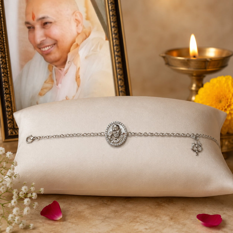 My Guru Ji silver-finish brass bracelet featuring a sacred portrait charm and trishul symbol on a satin cushion