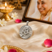 My Guru Ji round brass pendant with silver finish featuring an embossed portrait of Guru Ji on a satin cloth.
