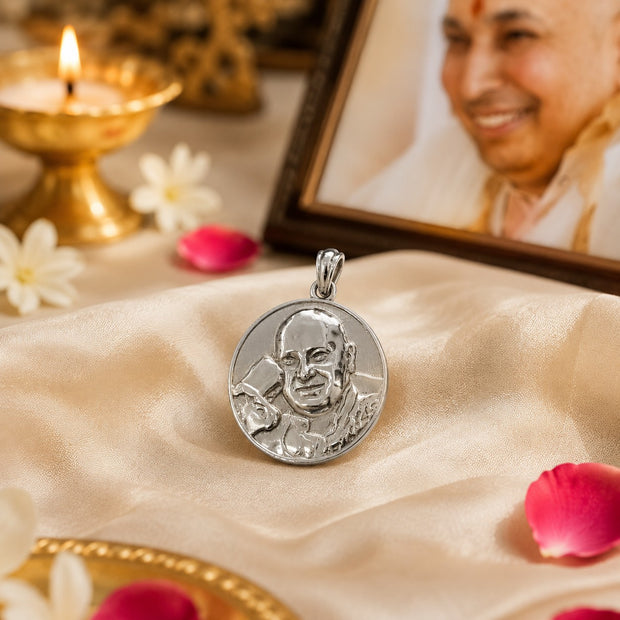 My Guru Ji round brass pendant with silver finish featuring an embossed portrait of Guru Ji on a satin cloth.