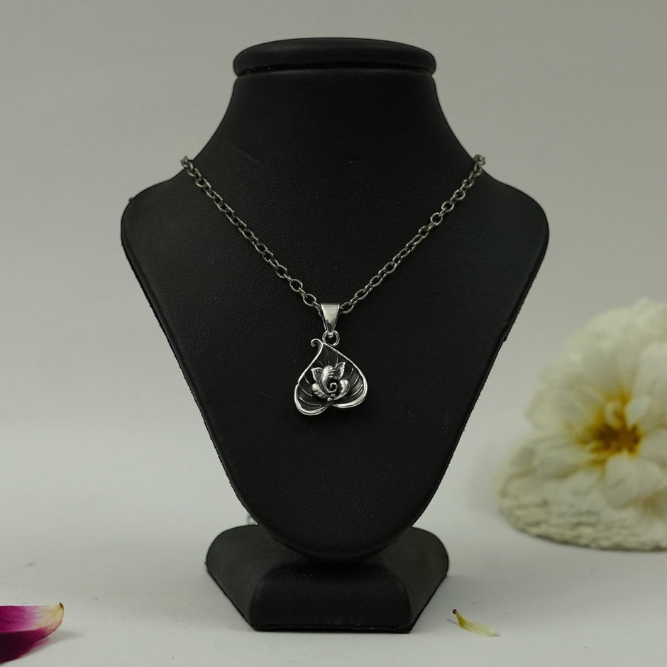My Guru Ji silver plated brass Lord Ganesha pendant featuring a seated Ganpati design on a black jewelry display bust.